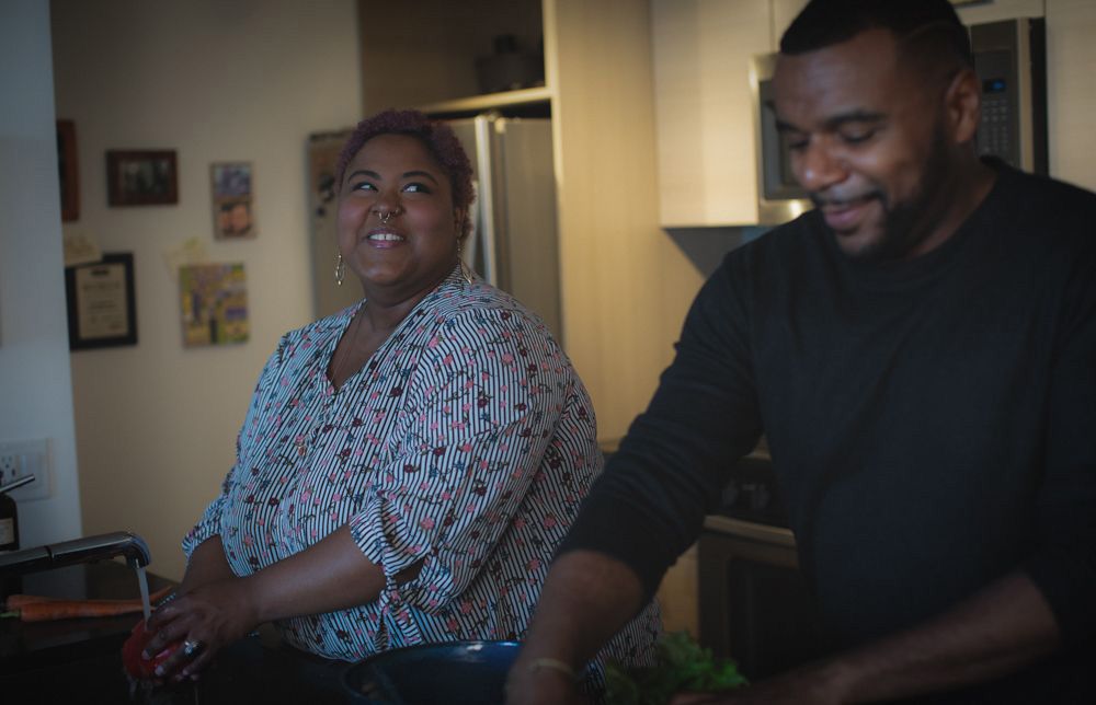 Black man and his female partner in the kitchen