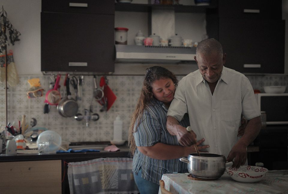 Black man and woman cooking together in the kitchen