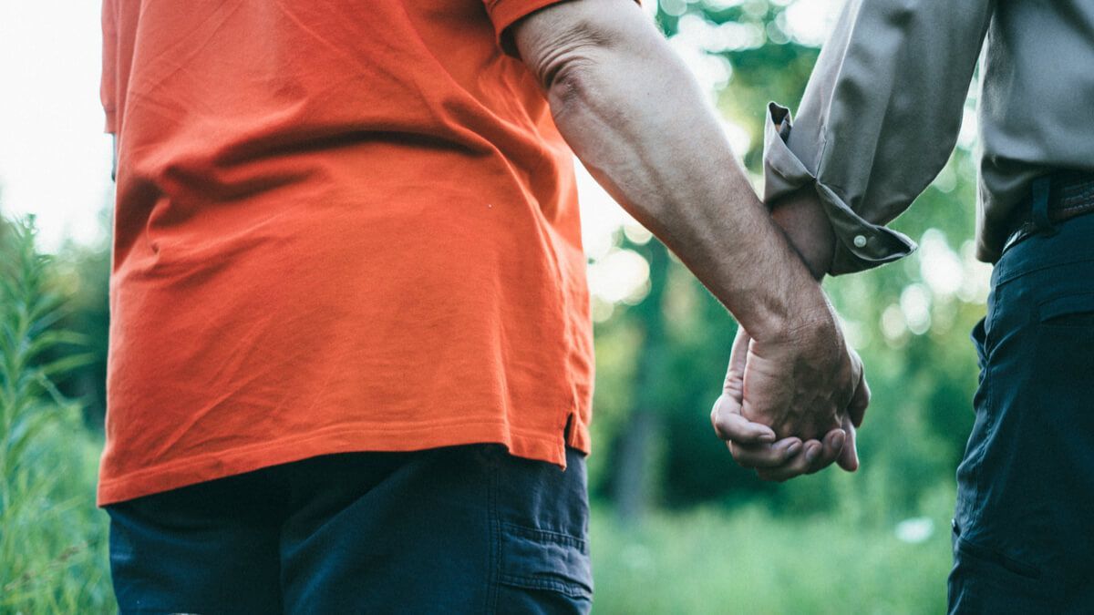 Two people holding hands