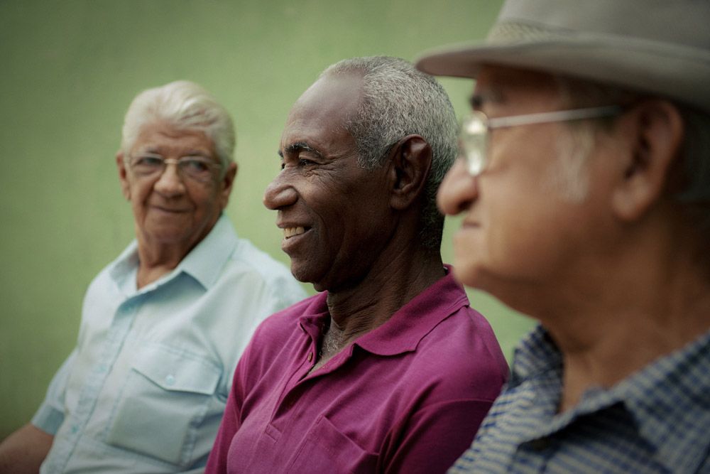 Close up of Black man sitting with two other men