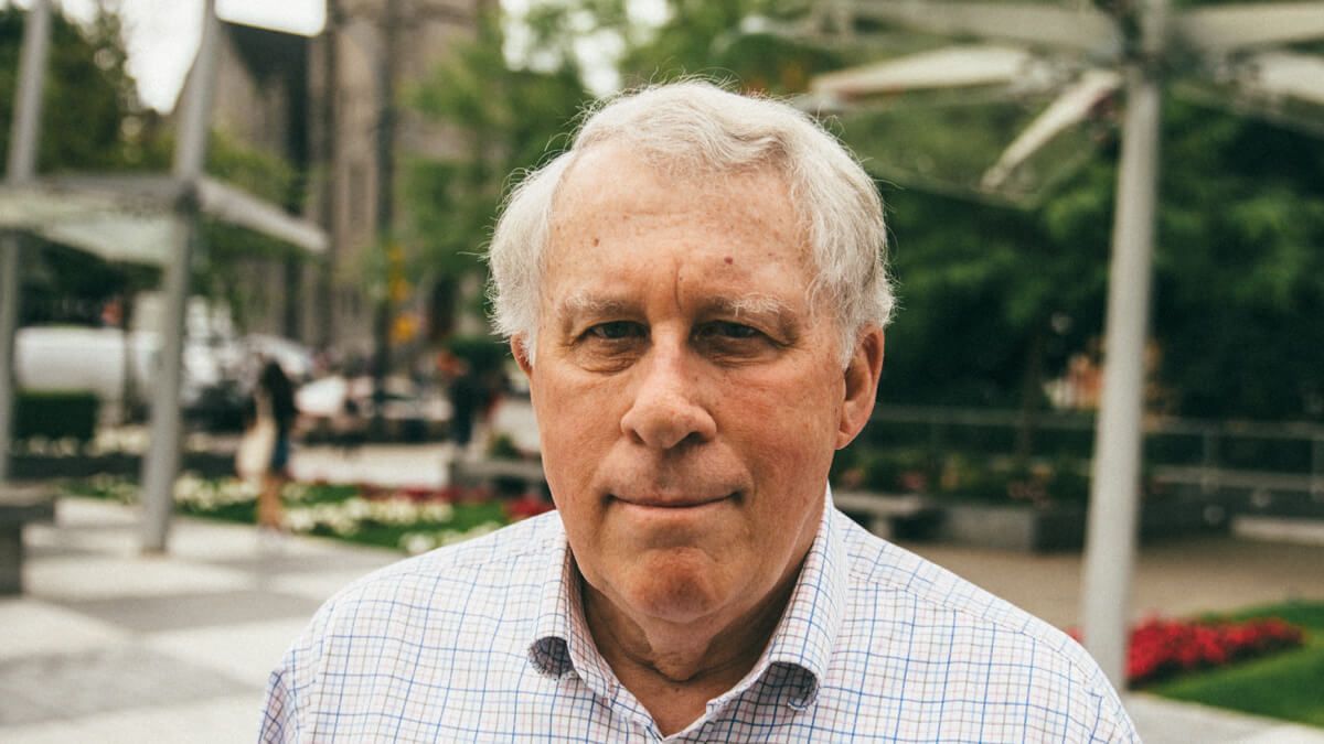 Close up of older man standing in a city square