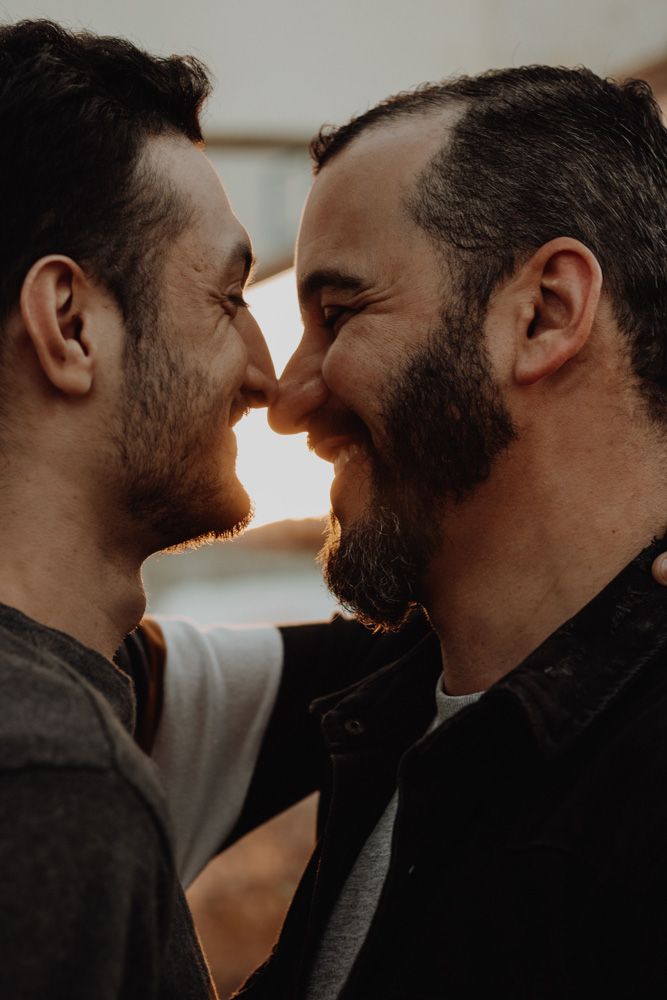 Close up of two men standing close and facing each other