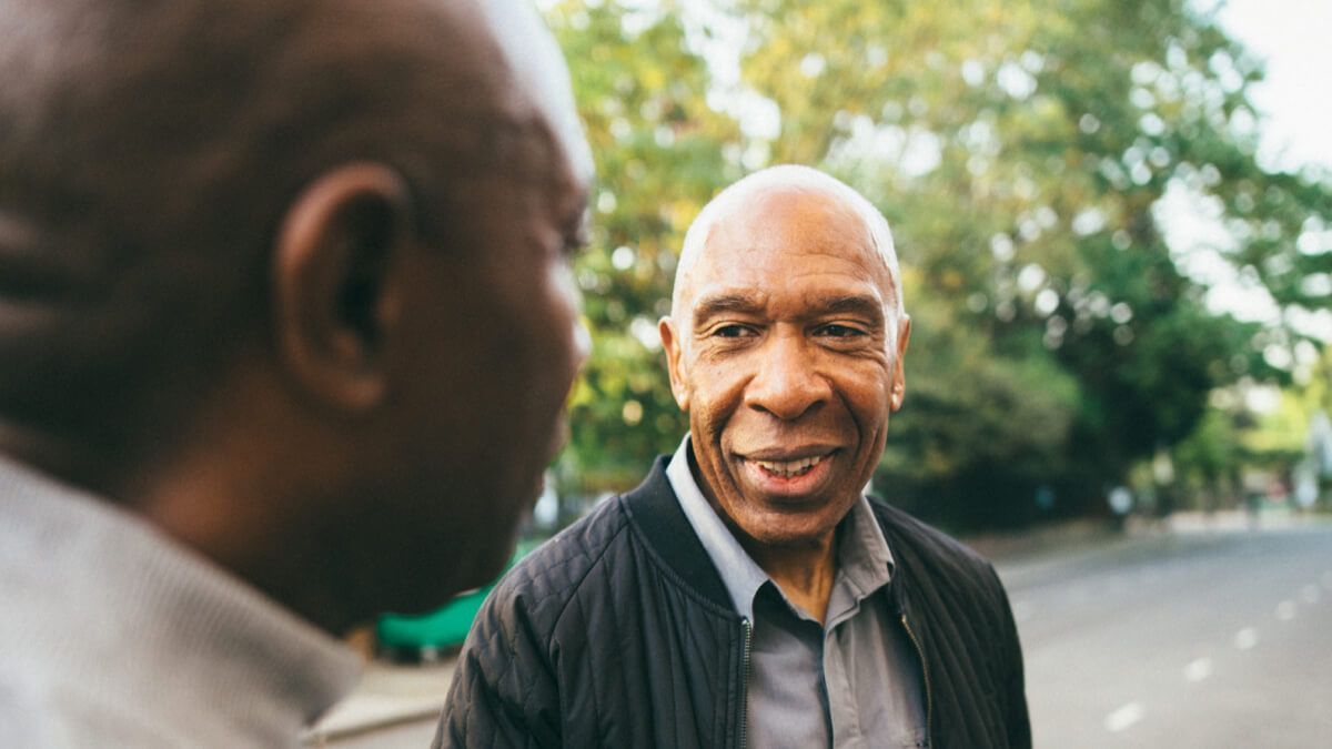 Close up of two Black men talking to each other 