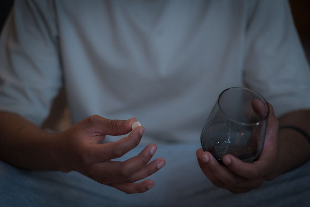 Close up of man about to take a pill